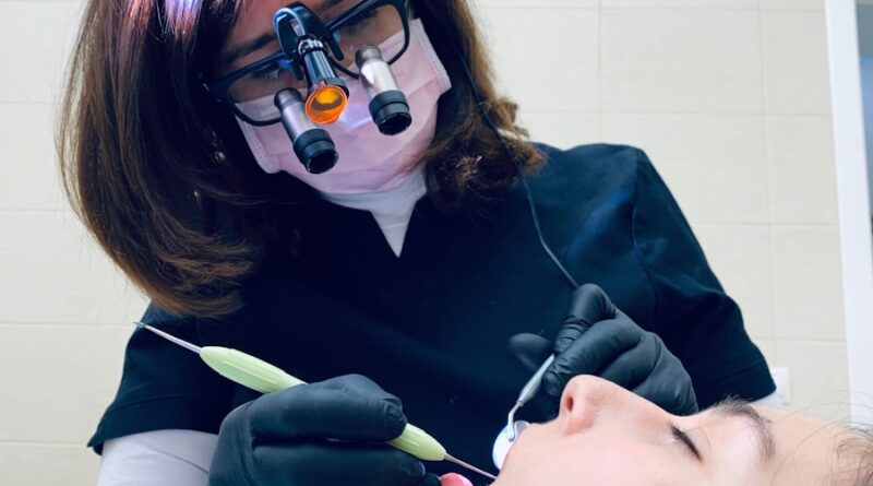 woman holding medical tool on person's mouth